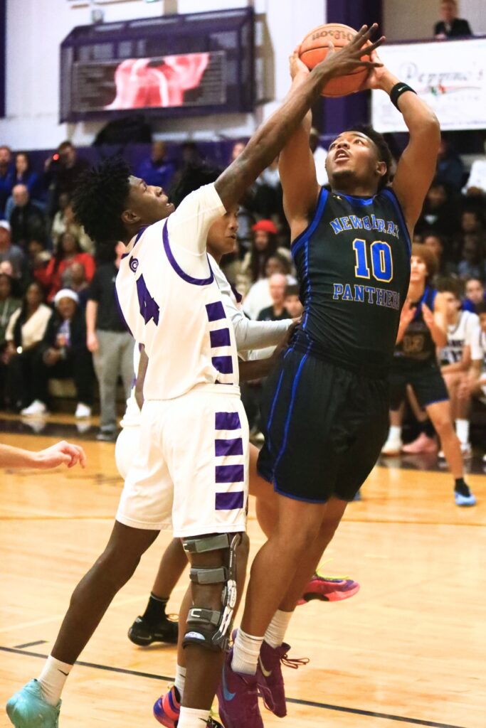 Gainesville's Craig Thomas Jr. (4) blocks a shot by Newberry's Darius Debose (10). Photo by C.J. Gish