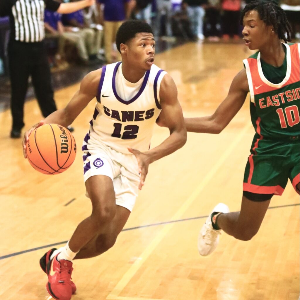 Gainesville's Jaishawn Sanford (12) drives to the basket against Eastside's Jermaine Gladin (10). Photo by C.J. Gish