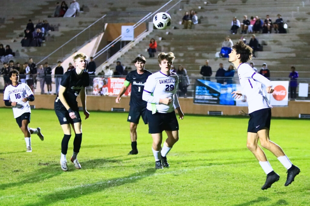 Gainesville's Keenan Bish (7) keeps the ball away from the goal with a header against Buchholz. Photo by C.J. Gish