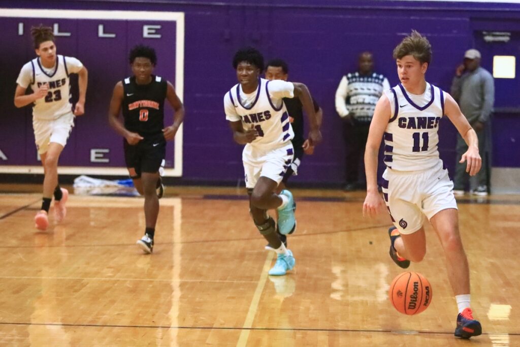 Gainesville's Kyle Pinter (11) pushes the ball down the court against Hawthorne. Photo by C.J. Gish