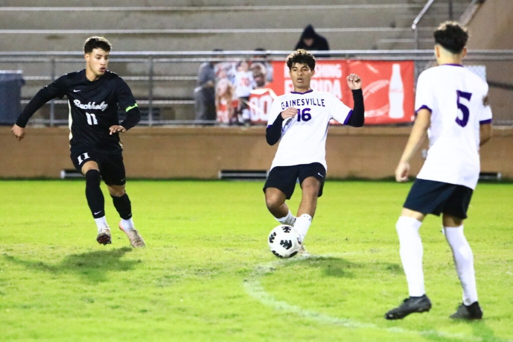 Gainesville's Leonardo Rosario (16) with a pass to teammate Jeffrey Ortega (5) against Buchholz's Carlos Cadet (11). Photo by C.J. Gish