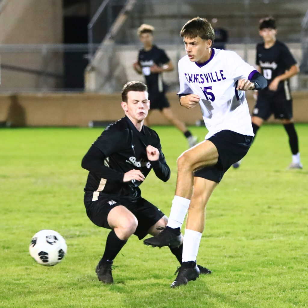 Gainesville's Luca Verloove (15) kicks the ball past Buchholz's Becket Sutton (17). Photo by C.J. Gish