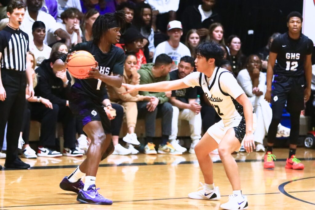 Gainesville's Willie Brooks (1) defended by Buchholz's Ezra Olmedo (12). Photo by C.J. Gish