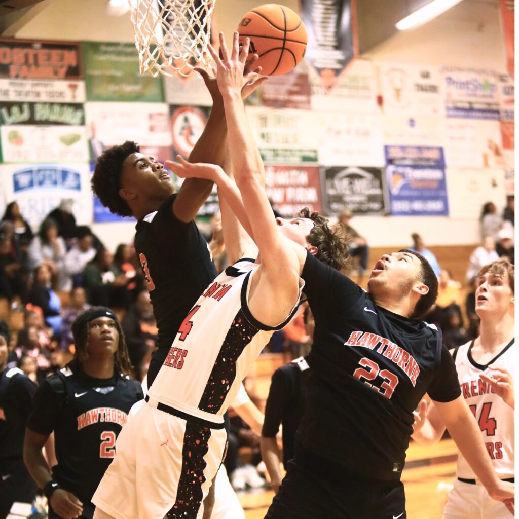 Hawthorne's Dominick Harvey (3) and Talon Harris (23) battle Trenton's Noah Owens (4) for a rebound. Photo by C.J. Gish