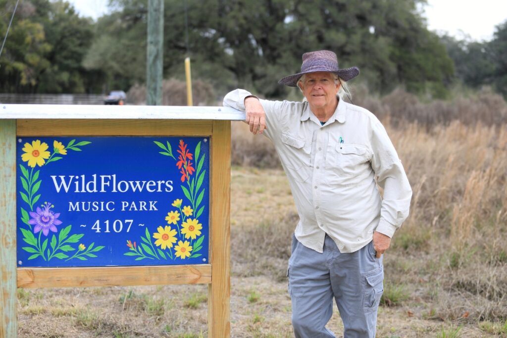 Hutch Hutchinson stands at the entrance to WildFlowers Music Park.
