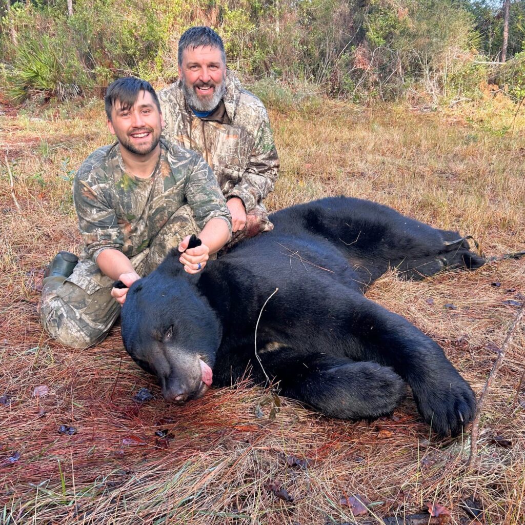 Jeff Nemeth, 57, and his son Rees Nemeth, 27, pose with an 8-foot-3 Florida black bear they harvested Dec. 9, 2025, in Eastpoint, Fla.