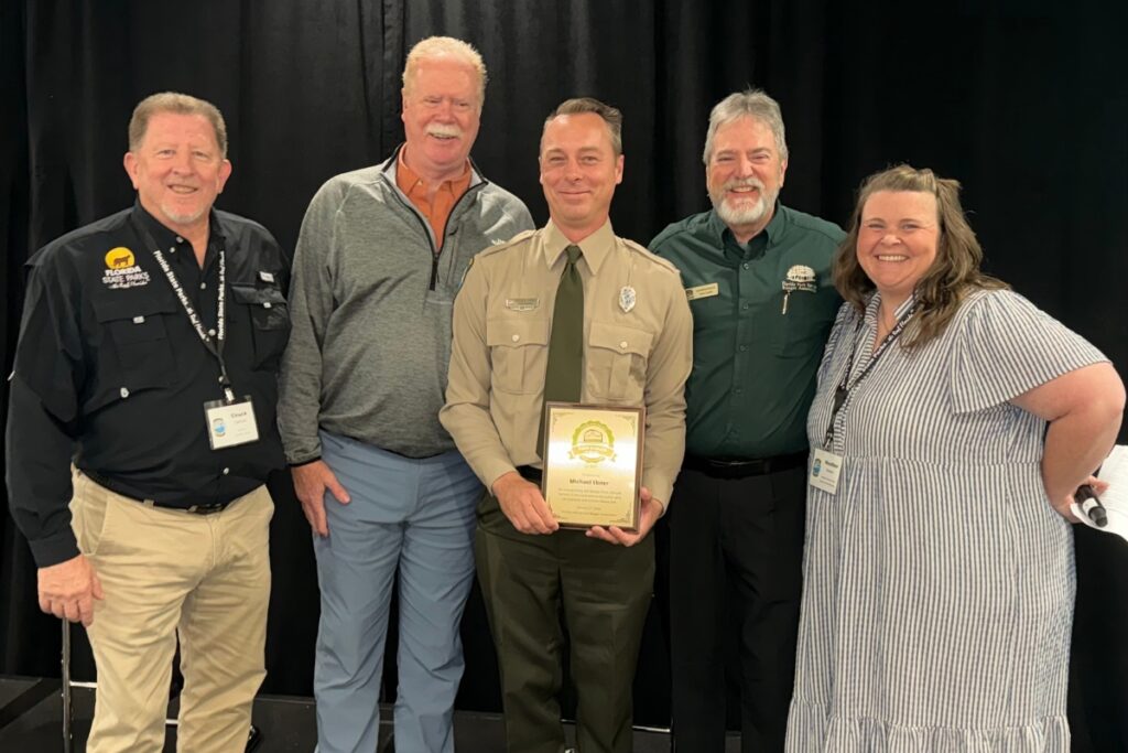 Michael Ebner receives his award at a Park Manager Meeting.