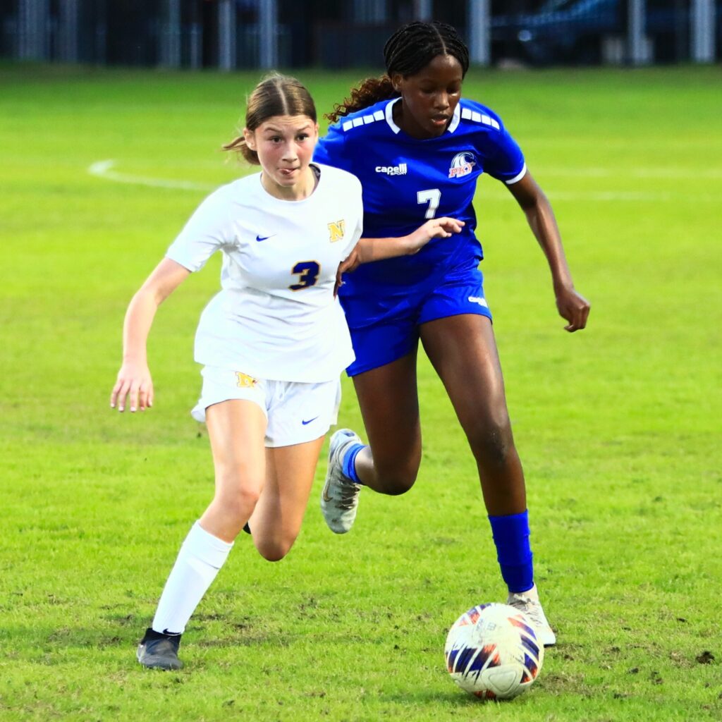 Newberry's Aubrey Schwab (3) and P.K. Yonge's Michelle Katana (7) battle for the ball. Photo by C.J. Gish