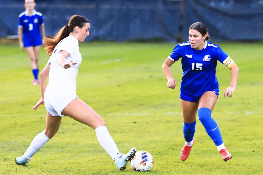 Newberry's Baylee Akers (7) goes to intercept the ball from P.K. Yonge's Ellie Cervantes (15). Photo by C.J. Gish