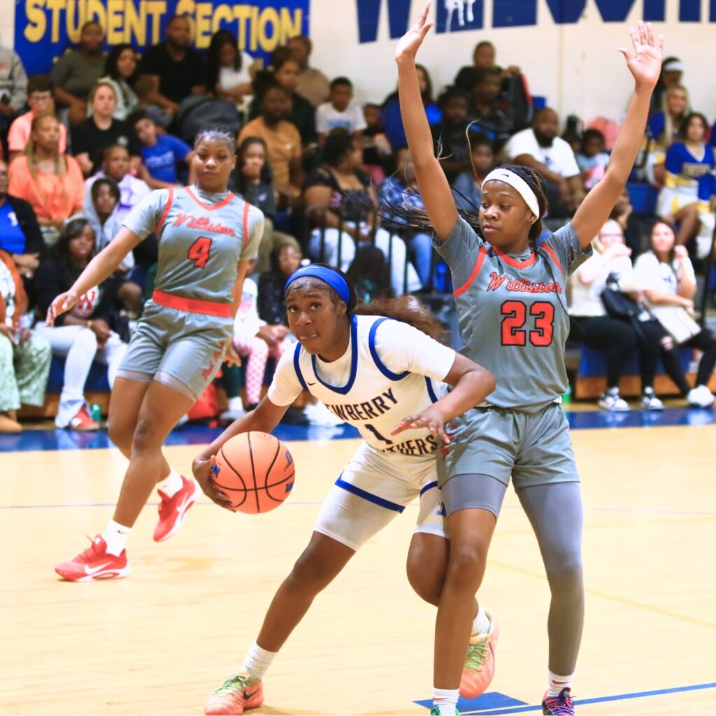 Newberry's Brandy Whitfield (1) drives to the basket against Williston's Teayla Duncan (23). Photo by C.J. Gish