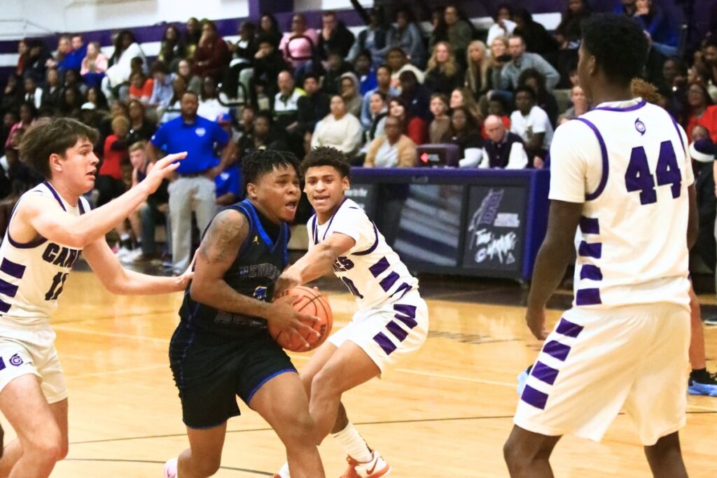 Newberry's Craig Middleton (0) drives to the basket against Gainesville. Photo by C.J. Gish
