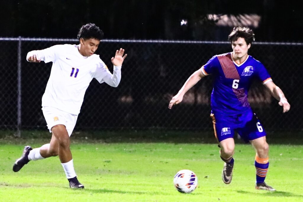 Newberry's Daniel Rodriguez (11) and P.K. Yonge's David Demers (6) go after the ball. Photo by C.J. Gish