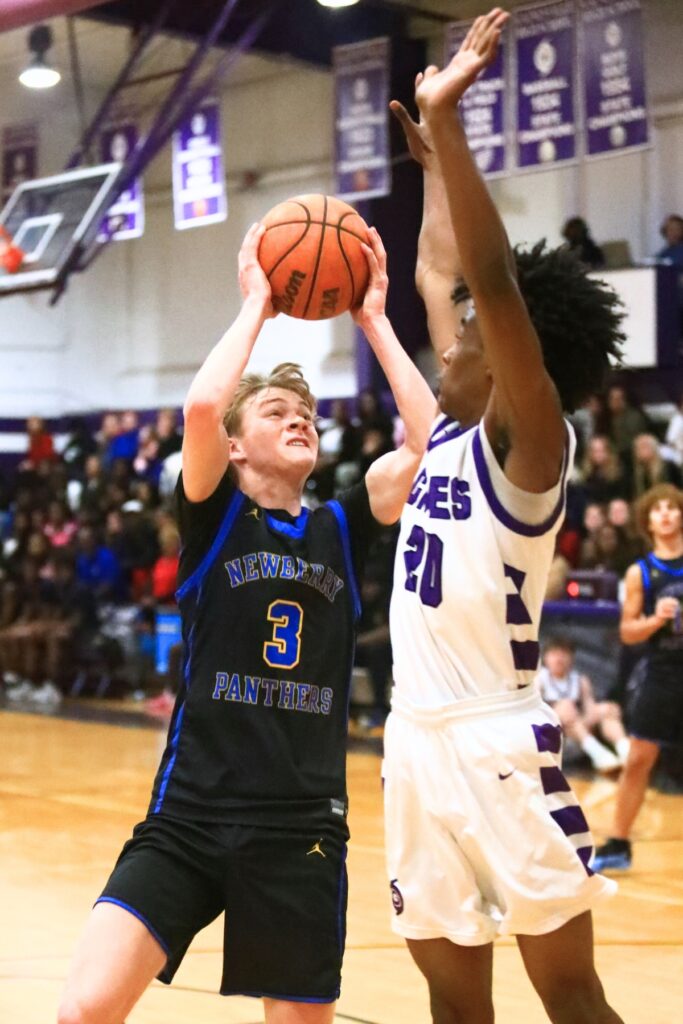 Newberry's Henry Mathias (3) puts up a shot against Gainesville's Anthony Jenkins Jr. (20). Photo by C.J. Gish