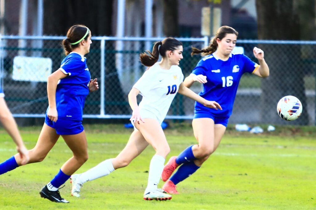 Newberry's Isabella Barley (10) and P.K. Yonge's Taylor Hass (10) go after the ball. Photo by C.J. Gish