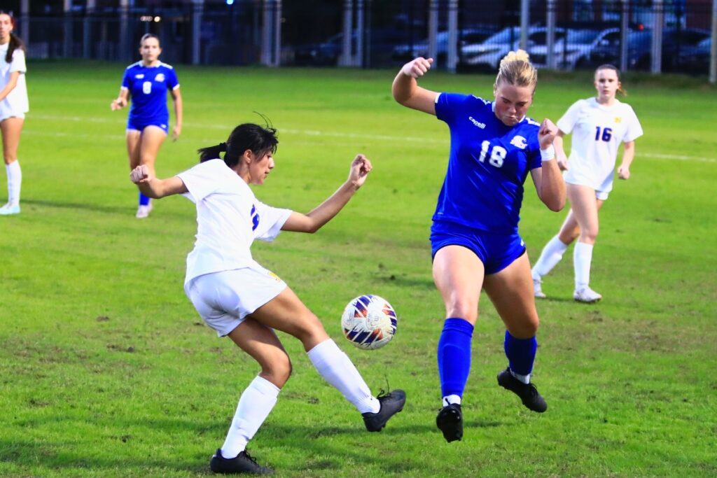 Newberry's Jazleyn Linares (19) and P.K. Yonge's Ryleigh Luca (18) go after the ball. Photo by C.J. Gish