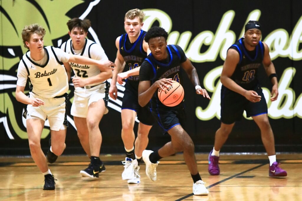 Newberry's Juwan Scippio (24) drives down court against Buchholz. Photo by C.J. Gish