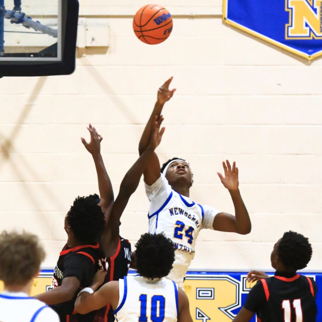 Newberry's Juwan Scippio (24) goes after a loose ball against Williston. Photo by C.J. Gish