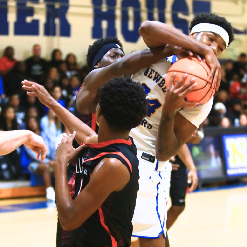 Newberry's Juwan Scippio (24) pulls down a rebound against Williston. Photo by C.J. Gish