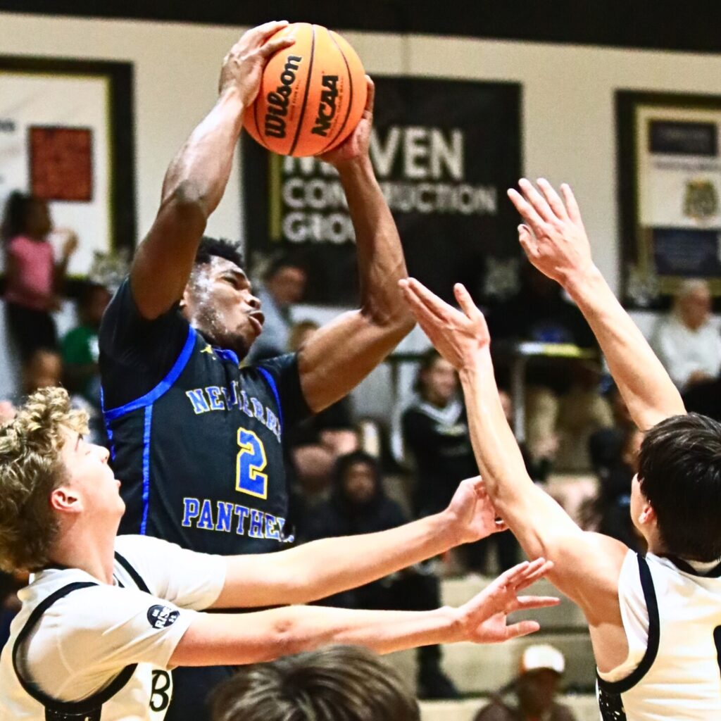 Newberry's Kaleb Woods (2) with a rebound against Buchholz. Photo by C.J. Gish