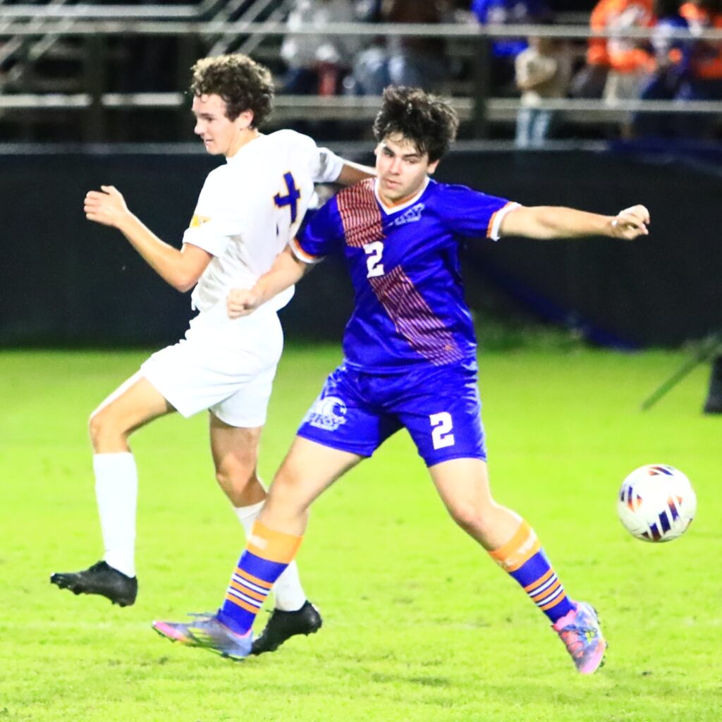 Newberry's Lucas Nowels (14) and P.K. Yonge's Justin Kovarn (2) go after the ball. Photo by C.J. Gish