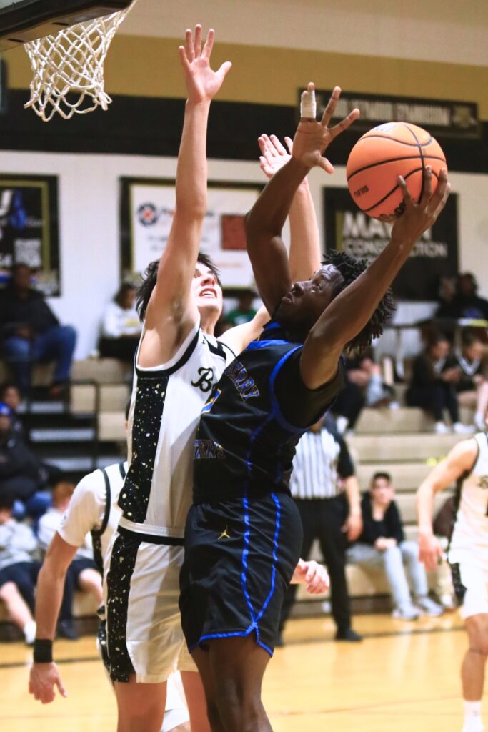 Newberry's Quantez Robinson (1) puts up a shot against Buchholz's Jacob Bromirski (0). Photo by C.J. Gish