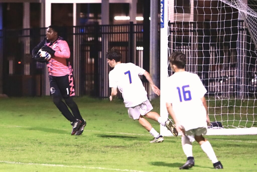 P.K. Yonge goal keeper Regan Hollinger (1) with a save against Newberry. Photo by C.J. Gish