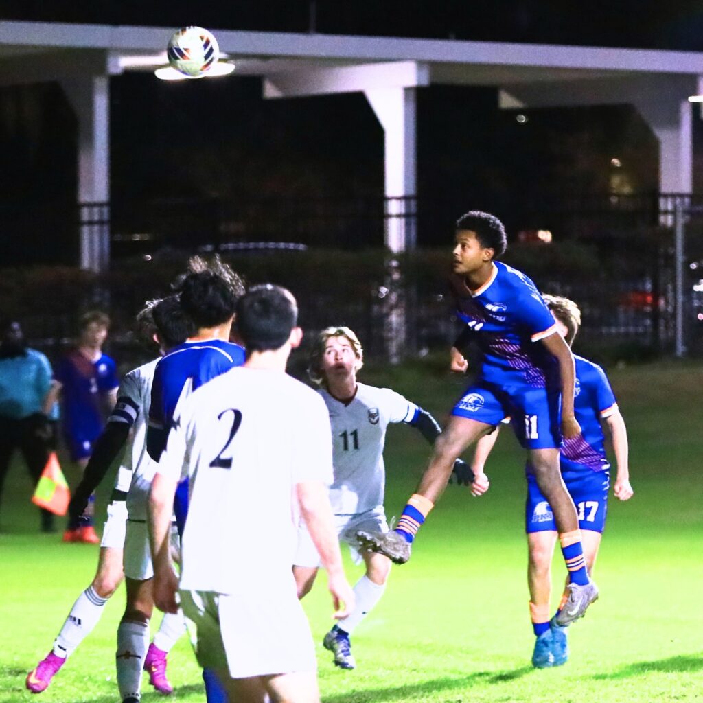 P.K. Yonge's Ethan Bertrand (11) with a header shot on goal against Williston. Photo by C.J. Gish