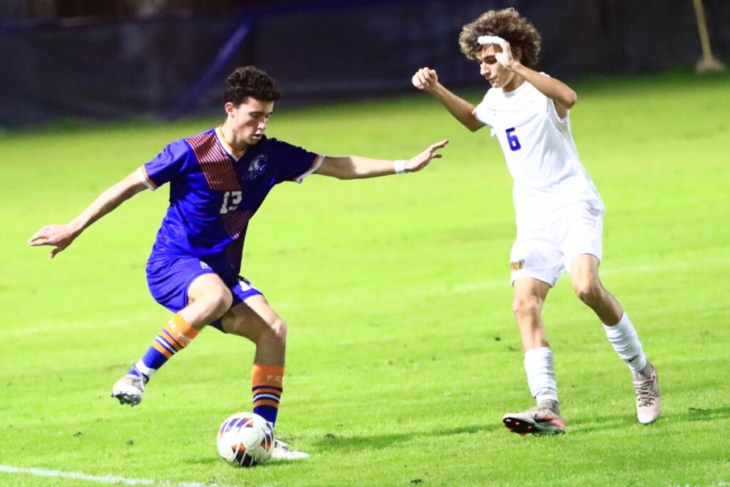 P.K. Yonge's Fisher Cooper (13) defended by Newberry's Josiah Stewart (6). Photo by C.J. Gish