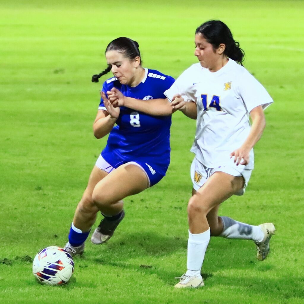 P.K. Yonge's Khloe Sanchez (8) and Newberry's Angie Lopez (14) battle for the ball. Photo by C.J. Gish