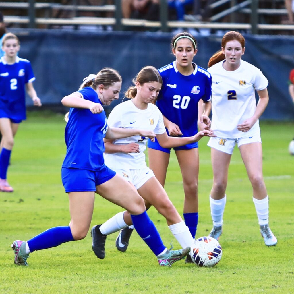 P.K. Yonge's Paige Hegland (13) and Newberry's Aubrey Schwab (3) battle for the ball. Photo by C.J. Gish