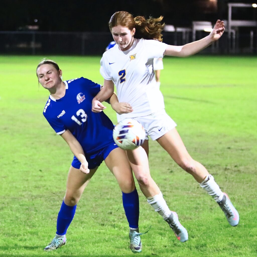 P.K. Yonge's Paige Hegland (13) and Newberry's Mallory Smith (2) go for the ball. Photo by C.J. Gish