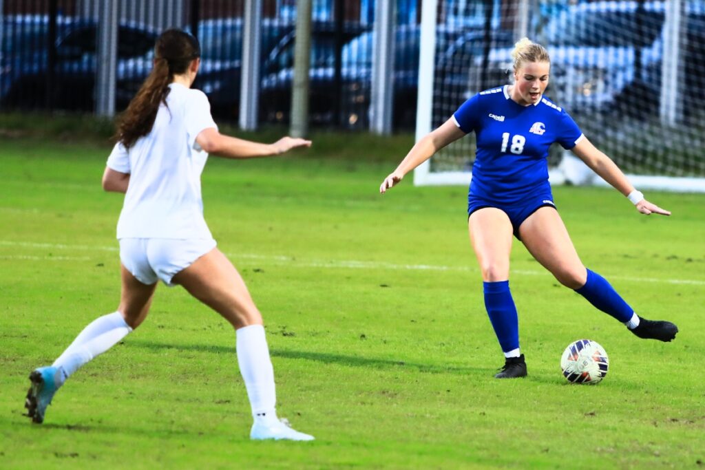 P.K. Yonge's Ryleigh Luca (18) kicks the ball downfield against Newberry. Photo by C.J. Gish