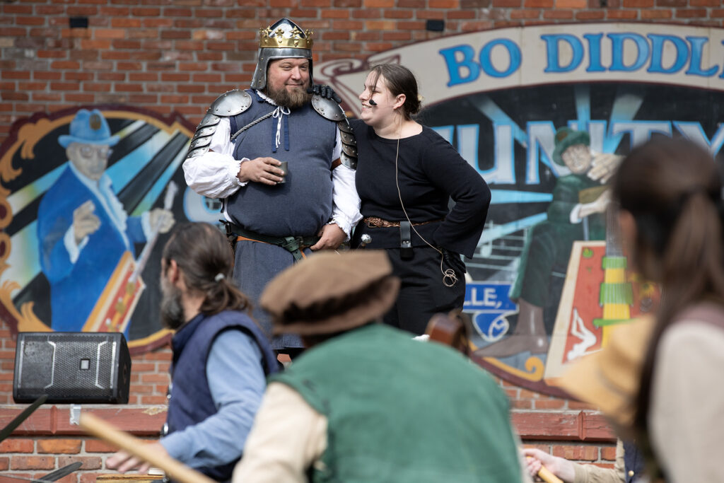 Performers exchange barbs during a Living Chessboard game. The game is a theatrical, life-sized version of chess in which players take turns moving human “pieces” around a board, and the pieces engage in one-on-one combat.