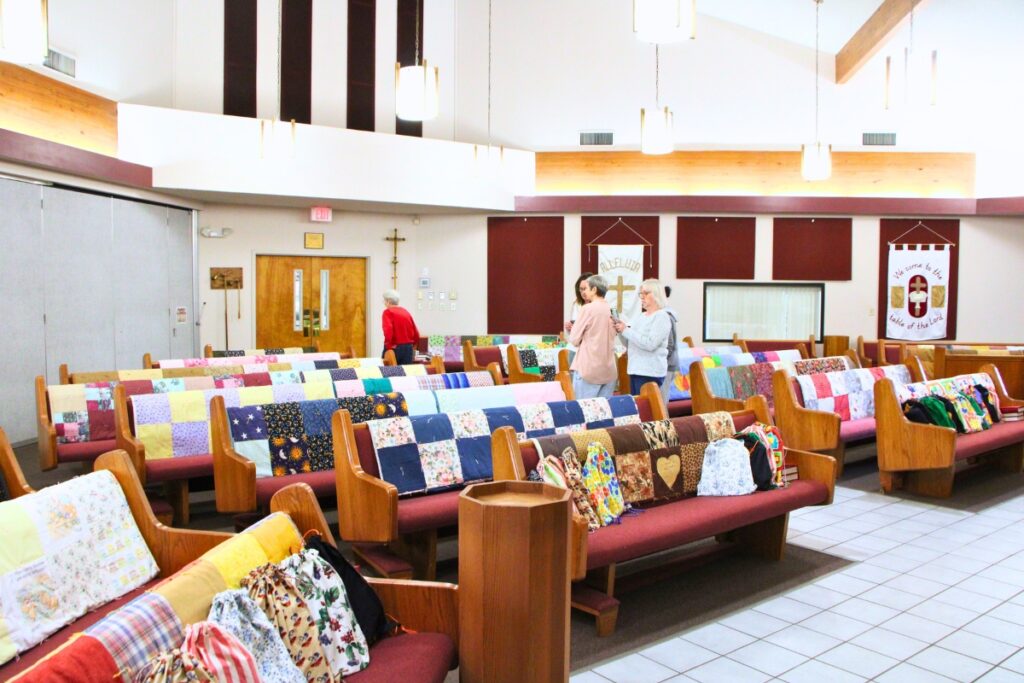 Quilts prepared for global relief missions by The Knotty Ladies in Gainesville will receive a blessing before Lutheran World Relief distributes them. Photo by Lillian Hamman