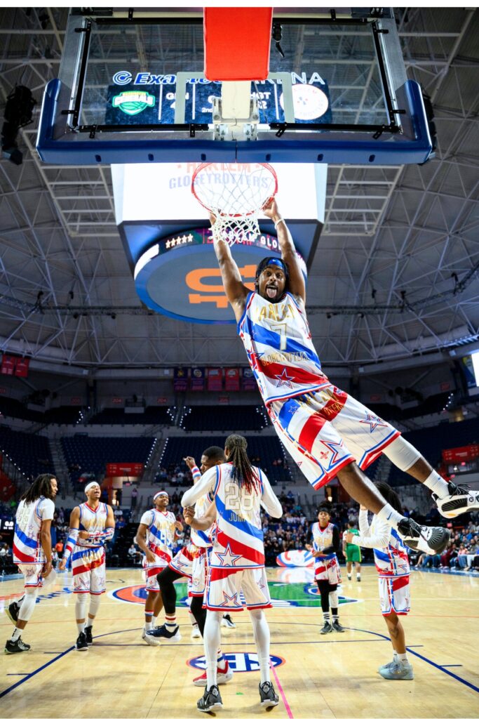 "Too Tall" dunks the basketball during the game at the Stephen O'Connell Center on Monday night.