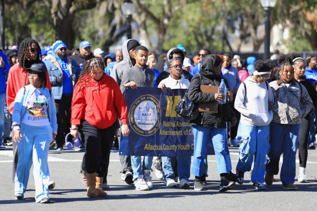 The NAACP Alachua County Youth Council marches down University Avenue for Martin Luther King Jr Day.