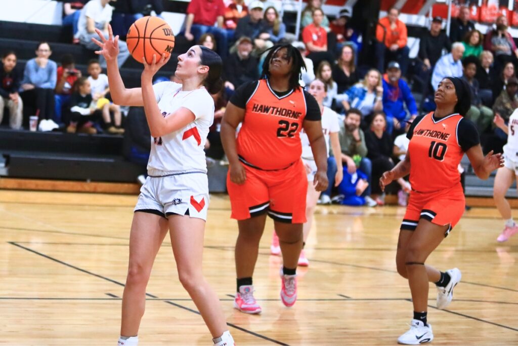 The Rock's Ellie Mittias (11) puts up a shot against Hawthorne. Photo by C.J. Gish