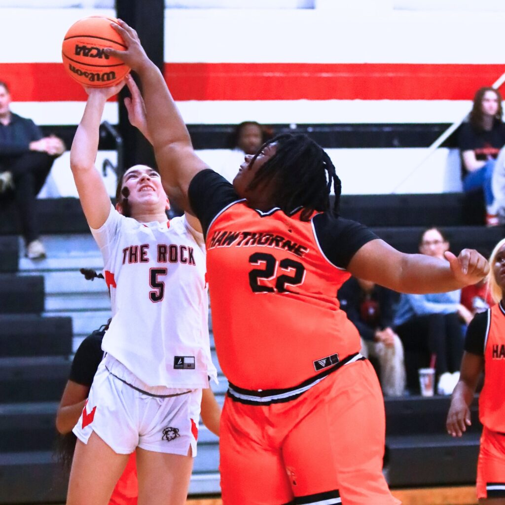 The Rock's Marlin Tyson (5) puts up a shot against Hawthorne's Brooklynn Gillins (22). Photo by C.J. Gish