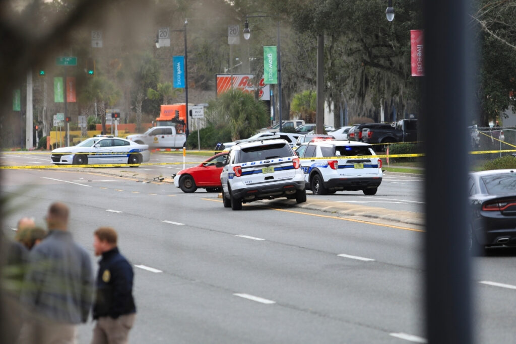 The gunman's vehicle remains in the middle of East University Avenue where it was stopped.