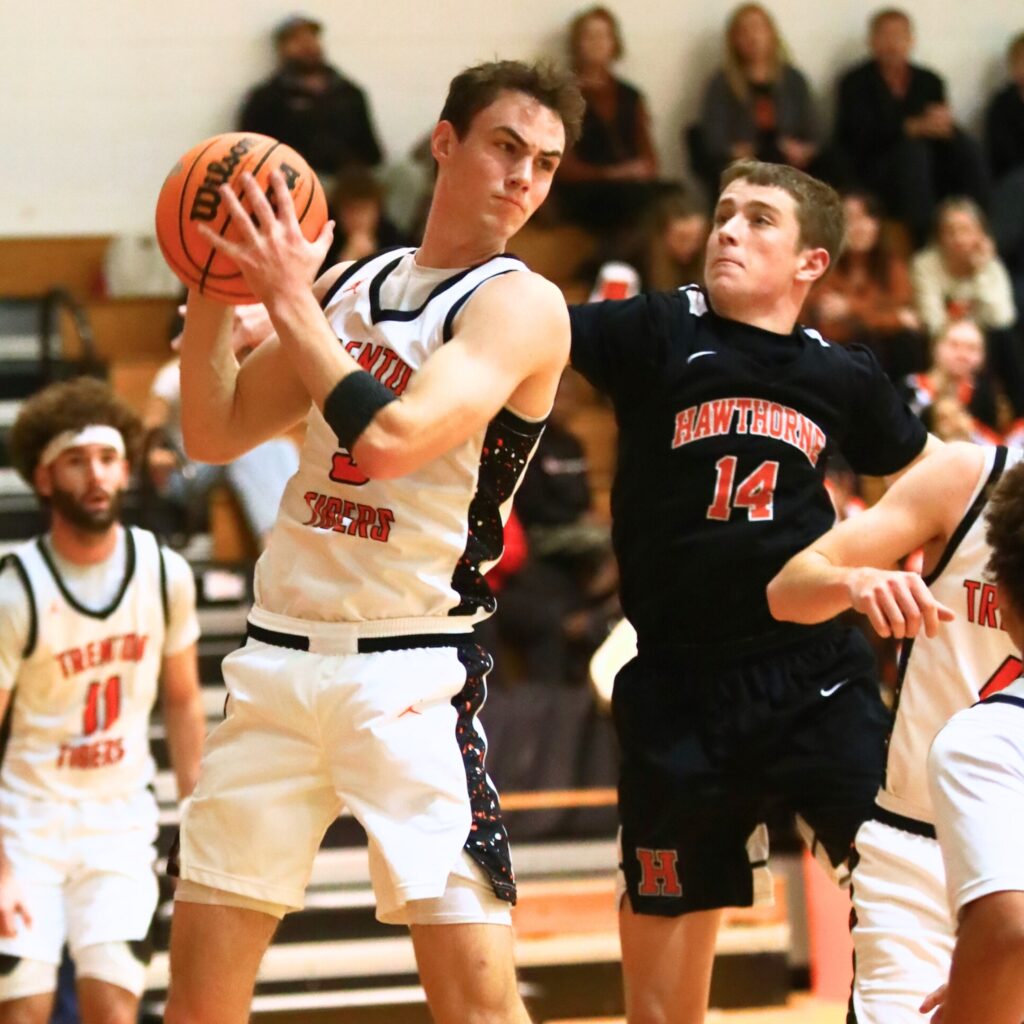 Trenton's Mason VunCannon (5) pulls down a rebound against Hawthorne. Photo by C.J. Gish