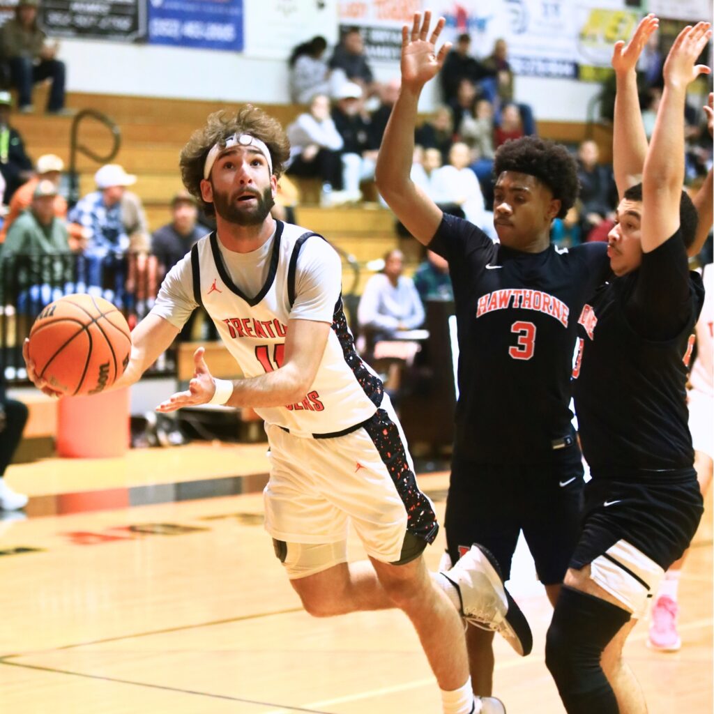 Trenton's Nathan Ridgell (11) puts up a shot against Hawthorne's Dominick Harvey (3) and Talon Harris (23). Photo by C.J. Gish