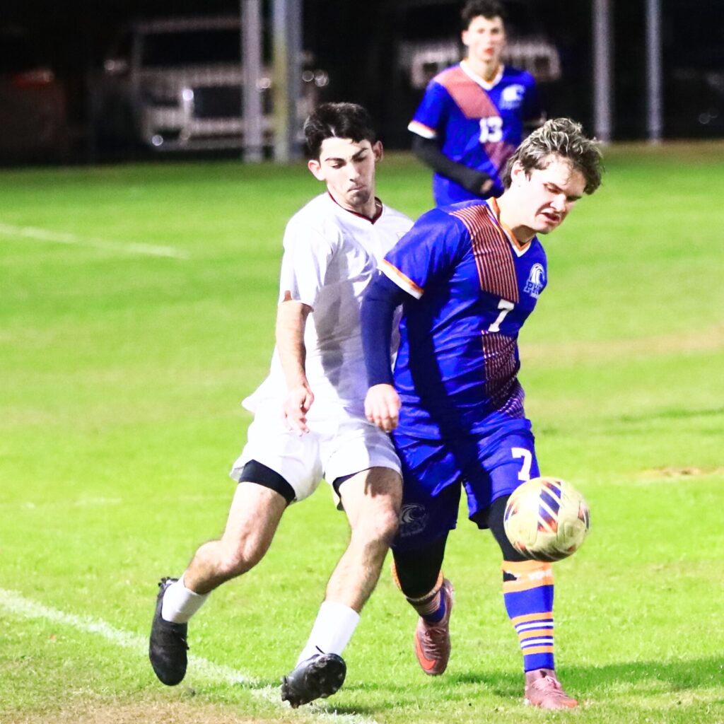 Williston's Braiden Muthard (2) and P.K. Yonge's Blake Firsching (7) battle along the sideline for the ball. Photo by C.J. Gish