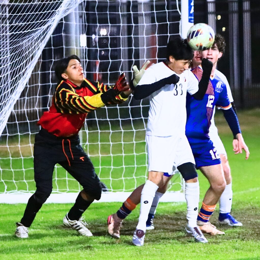 Williston's Eduardo Almanza (33) with a defensive header to keep a P.K. Yonge kick from entering the goal. Photo by C.J. Gish