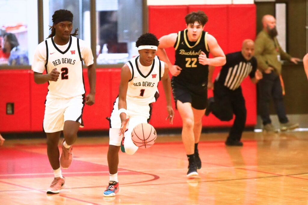 Williston's Marcus Appling (1) drives the ball downcourt against Buchholz. Photo by C.J. Gish