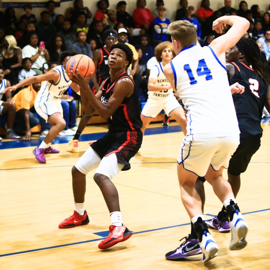 Williston's Marcus Appling (1) goes for a shot against Newberry's Colton Sembower (14). Photo by C.J. Gish