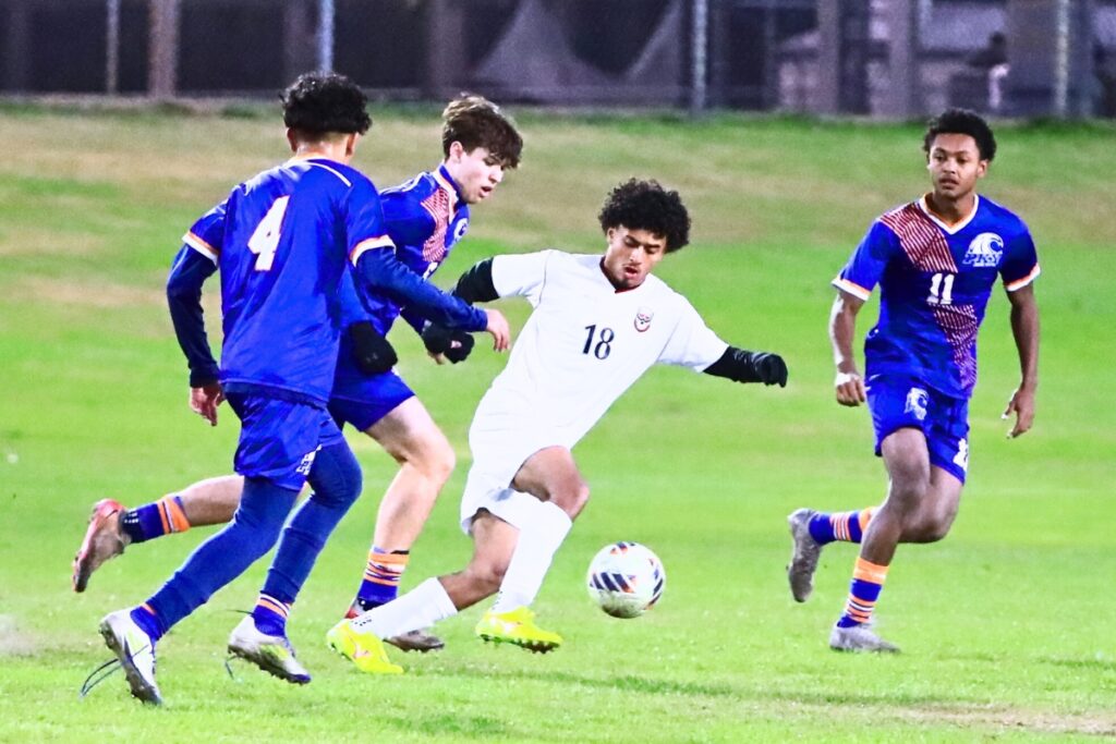 Williston's Yandel Mujica (18) surrounded by P.K. Yonge defenders. Photo by C.J. Gish