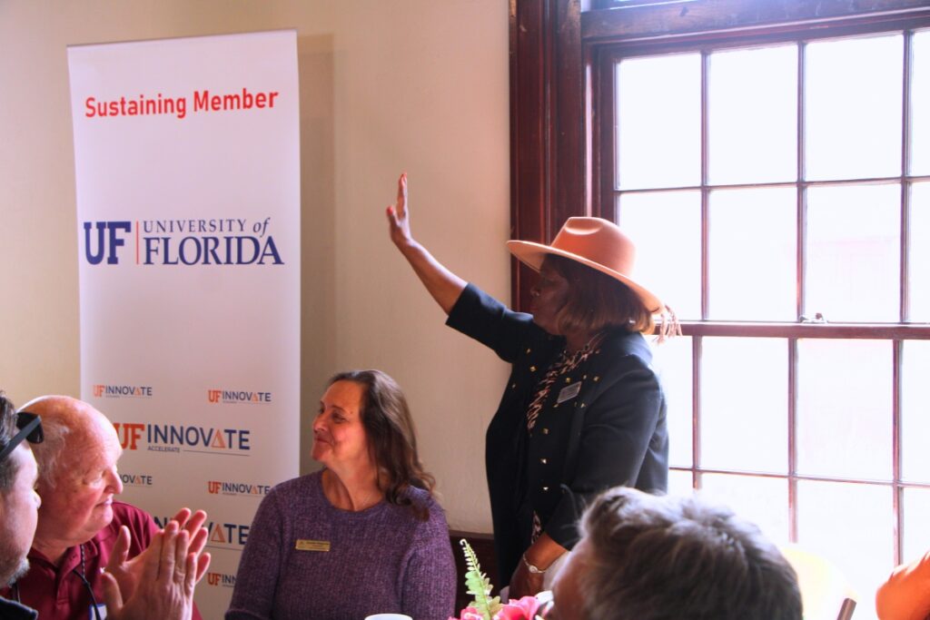 Alachua Commissioner Jennifer Ringersen (left) and Vice Mayor Shirley Green Brown (standing) attend the Chamber of Commerce's February luncheon. Photo by Lillian Hamman
