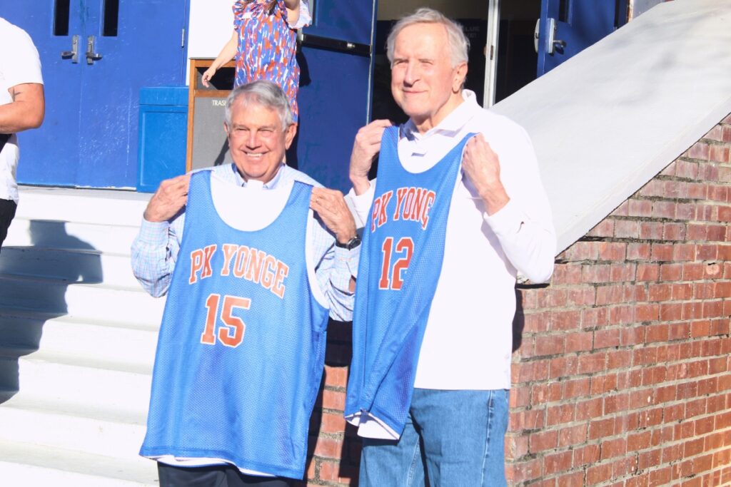Allen Lastinger (left) and Rick Smith pose for a photo with their new jerseys. Photo by Nick Anschultz