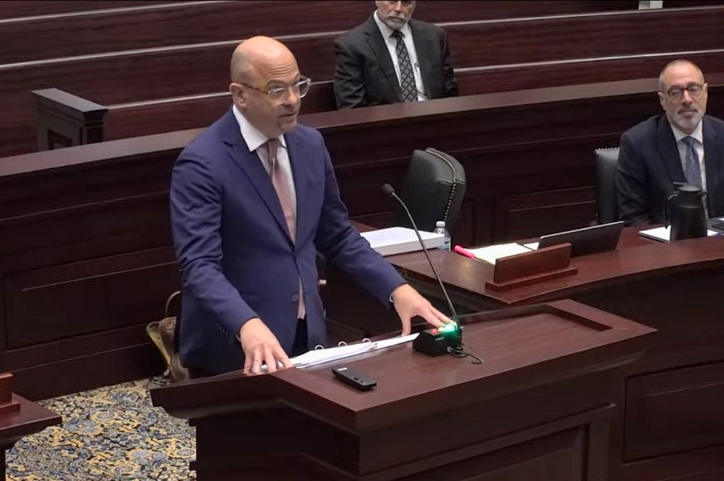 Attorney Sam Salario stands at a podium at the First District Court of Appeal.