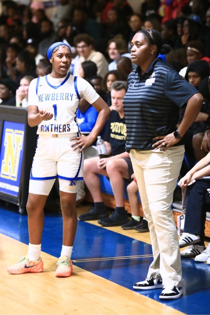 Brandy Whitfield (left) talks to Newberry coach Jessica Ross during a pause in a game. Photo by C.J. Gish